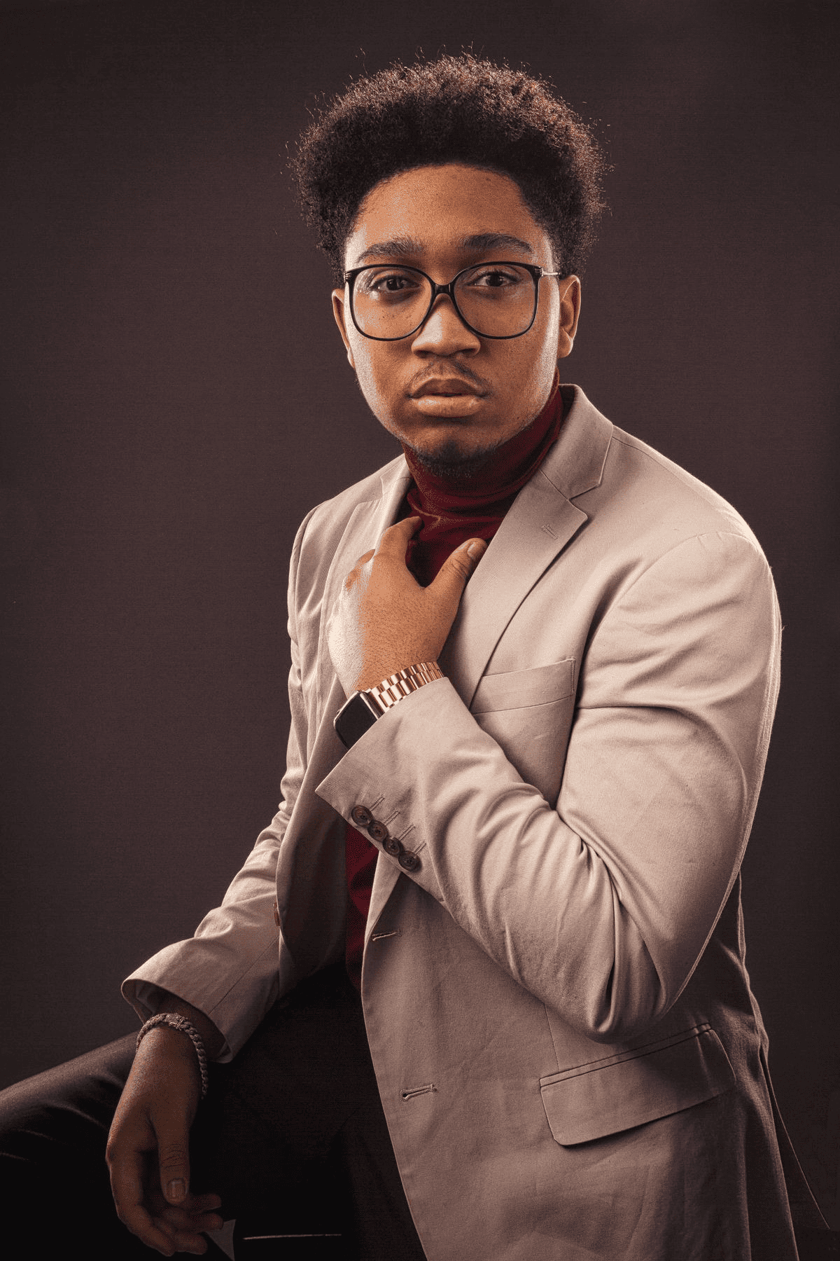 Public Qwen Image 3 reference showing a studio portrait of a man in a beige suit adjusting his tie.